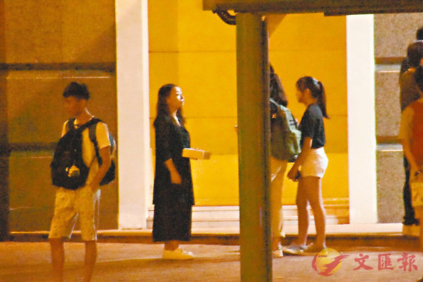 ■8月13日晚，劉小麗（左二�荈穠籪�者）鬼祟在荔枝角社區會堂入口外，用無標貼不透明紙盒涉嫌非法籌款。
