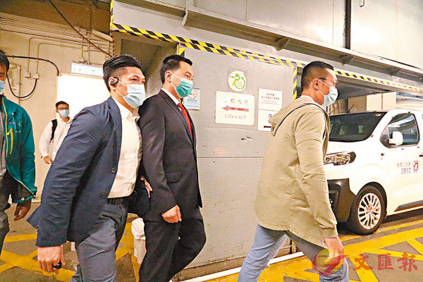 ■付國豪（右二）前天由警方護送離開法院。 香港文匯報記者 攝